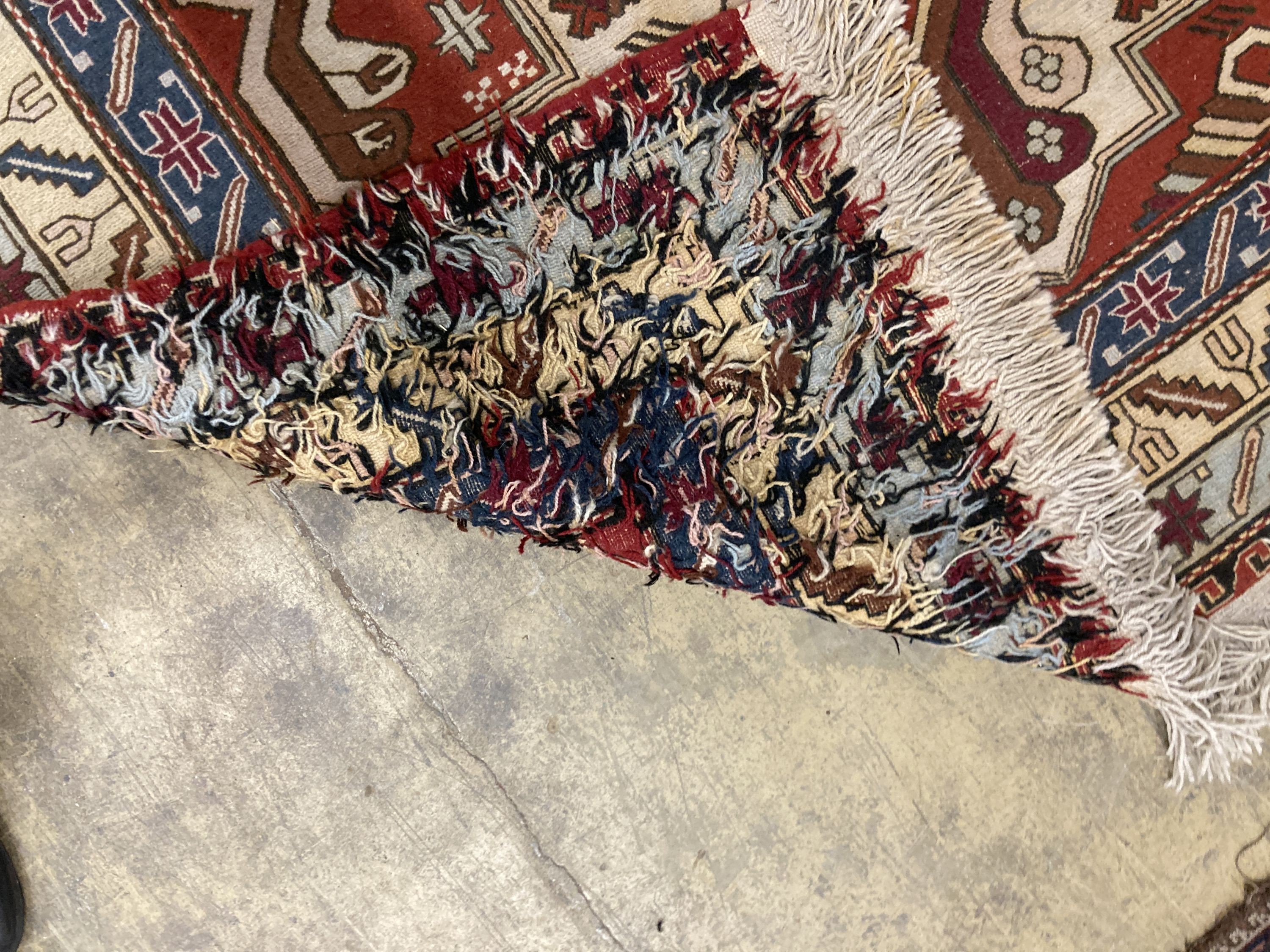 A Caucasian design red ground rug, 240 x 165 cms.